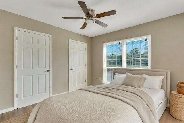 bedroom with ceiling fan and hardwood / wood-style flooring