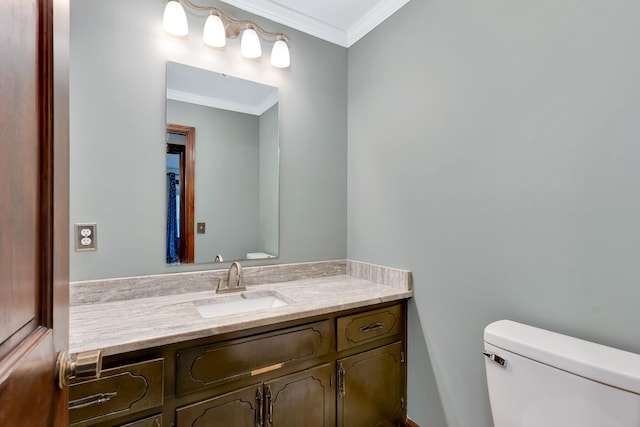 bathroom with crown molding, vanity, and toilet