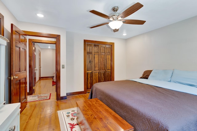 bedroom featuring a closet, light hardwood / wood-style floors, and ceiling fan