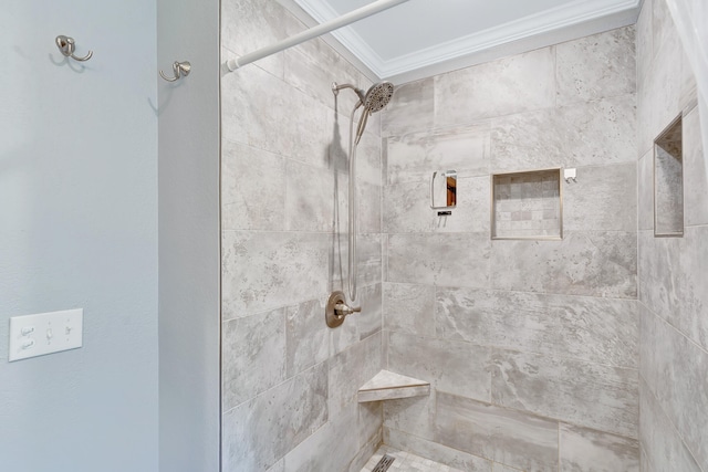 bathroom with a tile shower and ornamental molding