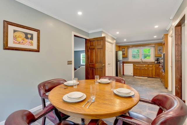 dining room featuring sink and crown molding