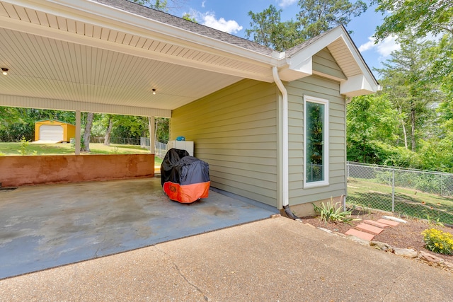 view of patio / terrace featuring a shed and a carport