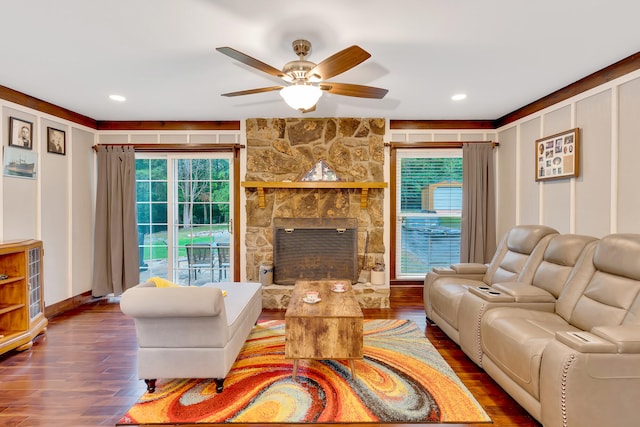 living room with a fireplace, hardwood / wood-style floors, and ceiling fan