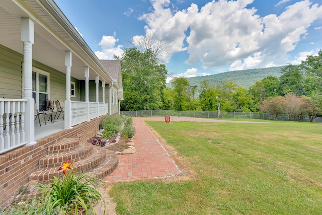 view of yard with a mountain view and a patio area