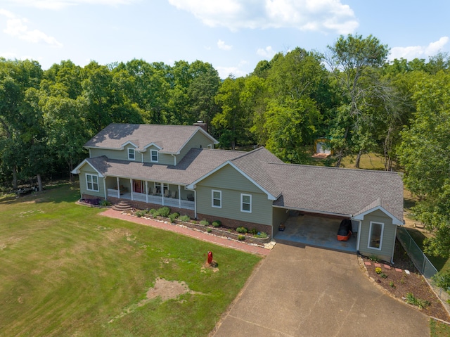 view of front of property featuring a front lawn, covered porch, and a carport