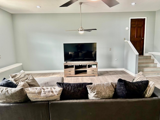 living room with light hardwood / wood-style floors and ceiling fan