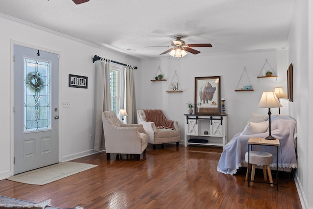 living room with ornamental molding, a wealth of natural light, ceiling fan, and dark hardwood / wood-style flooring