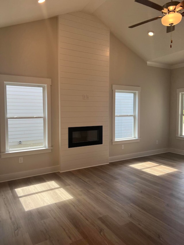 unfurnished living room featuring high vaulted ceiling, a large fireplace, ceiling fan, and dark hardwood / wood-style flooring