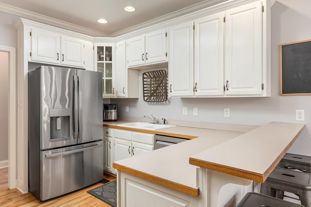 kitchen featuring white cabinets, light wood-type flooring, ornamental molding, and stainless steel fridge with ice dispenser