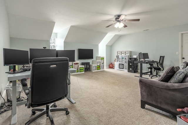 home office featuring vaulted ceiling, ceiling fan, and light colored carpet