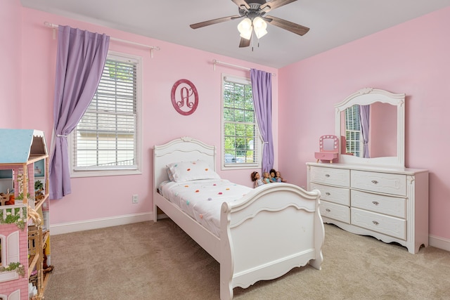 carpeted bedroom featuring ceiling fan and multiple windows