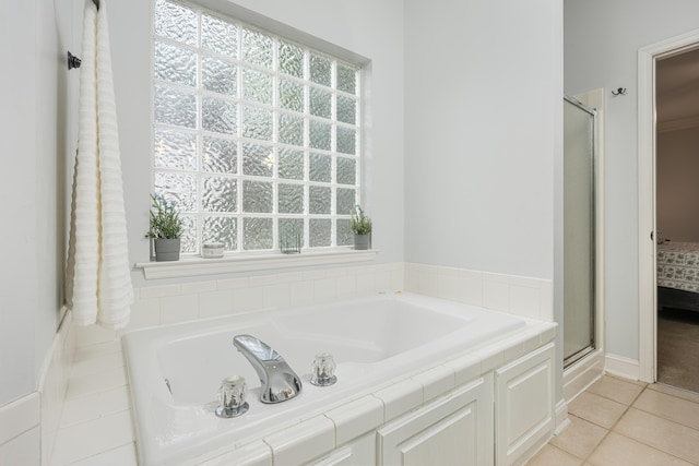 bathroom featuring shower with separate bathtub, plenty of natural light, and tile patterned floors