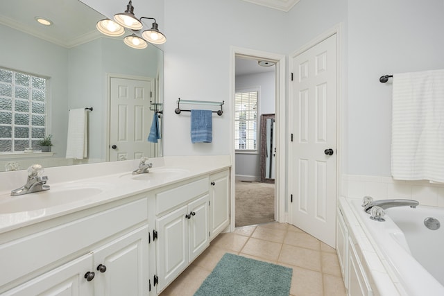 bathroom with vanity, tile patterned floors, a relaxing tiled tub, and crown molding