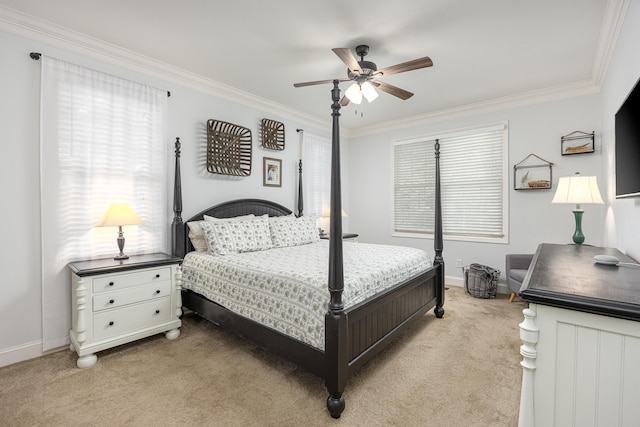 carpeted bedroom with ceiling fan and ornamental molding