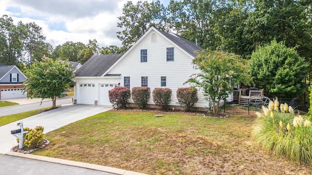 view of front of property featuring a garage and a front lawn