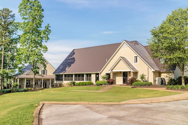 view of front of property with a front lawn and central AC