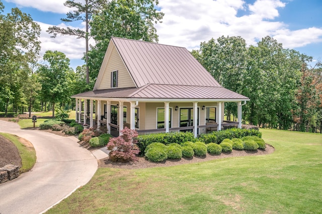 country-style home with a front lawn and a porch