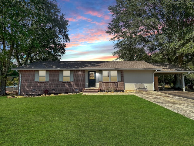 ranch-style house with a lawn and a carport