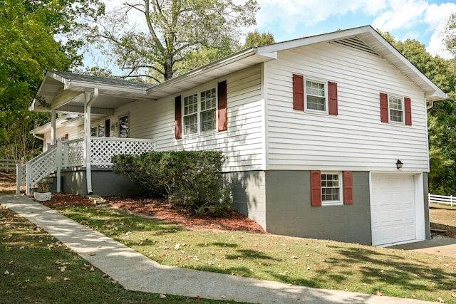 view of side of property with a lawn and a garage