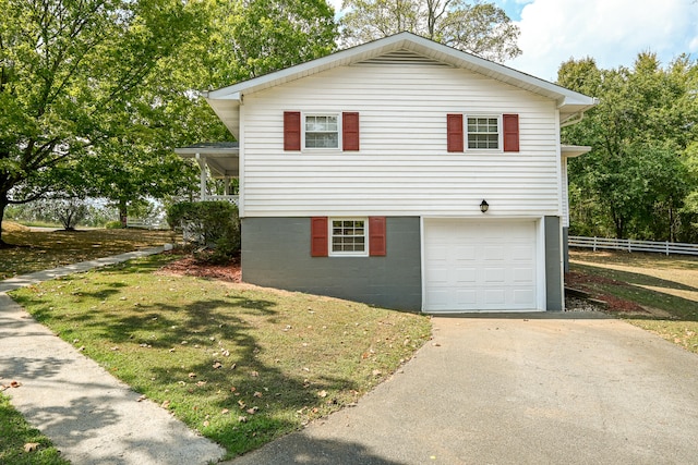 view of side of home with a yard and a garage