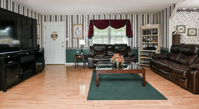 living room with light hardwood / wood-style floors and a textured ceiling