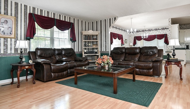 living room featuring a notable chandelier and light hardwood / wood-style floors