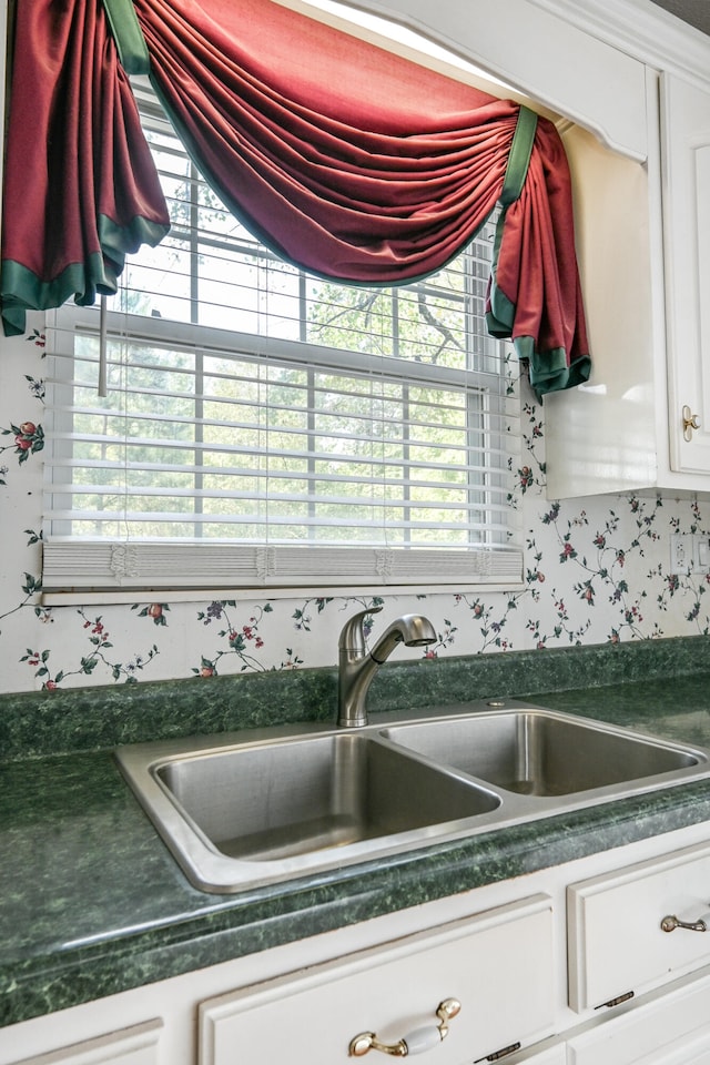 kitchen with plenty of natural light, sink, and white cabinetry