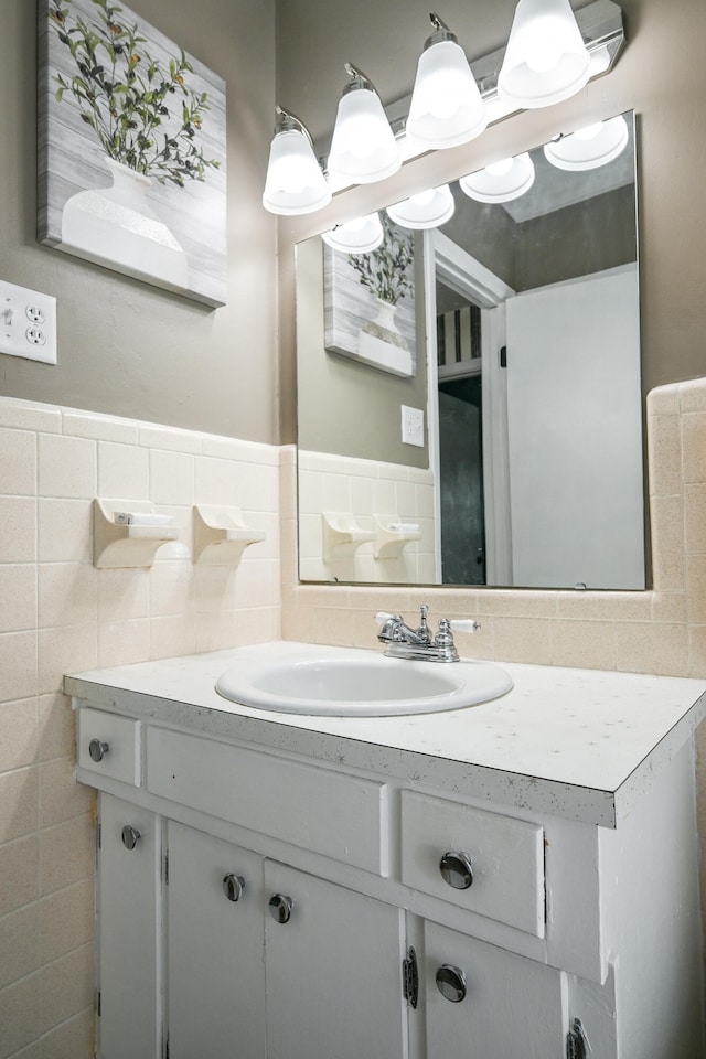 bathroom with vanity and tile walls