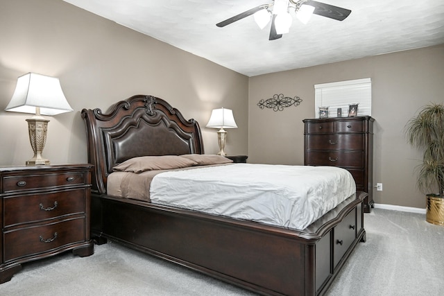 bedroom featuring light colored carpet and ceiling fan