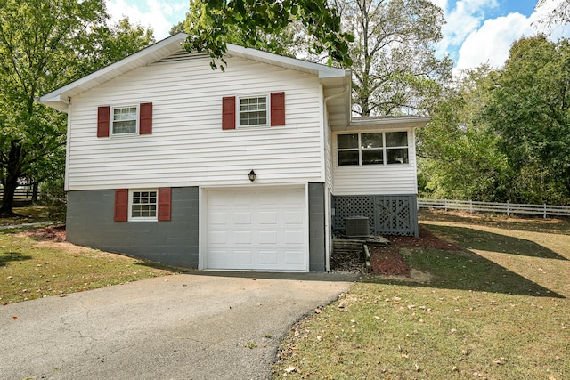 view of side of property with a garage and a lawn