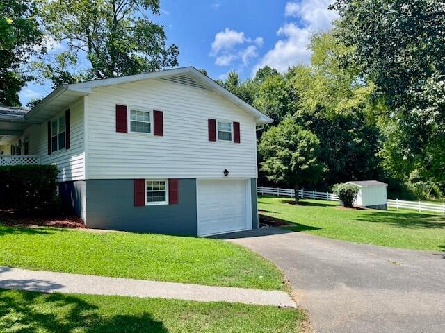 view of home's exterior with a garage and a yard