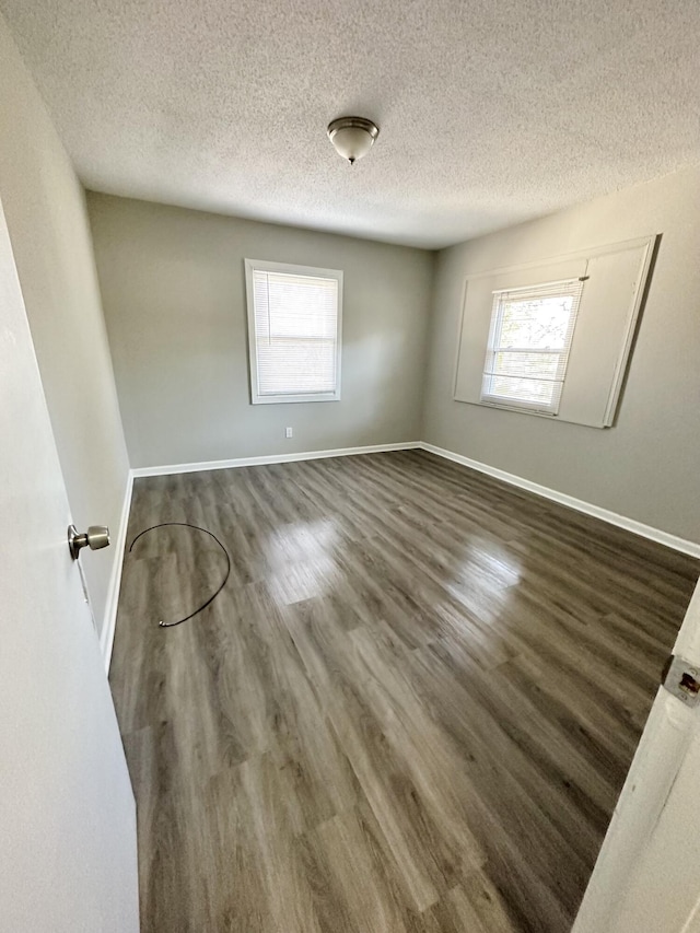 2 Bell Ave, Rossville, GA 30741 - spare room with dark wood-style flooring, baseboards, and a textured ceiling