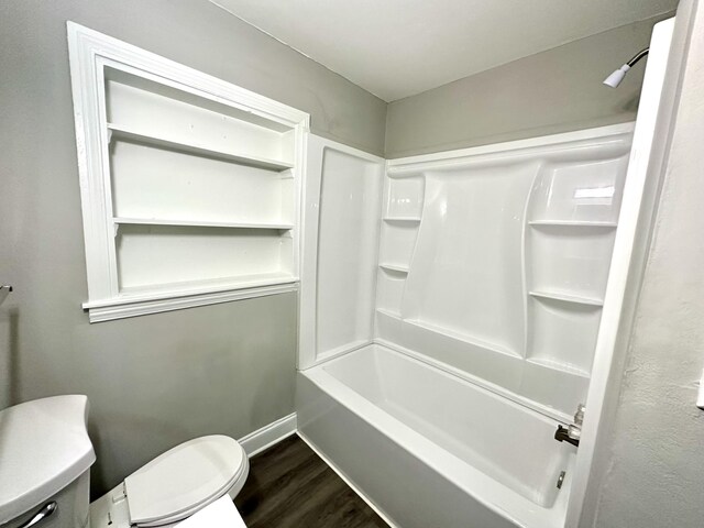 bathroom featuring shower / bathing tub combination, hardwood / wood-style floors, and toilet