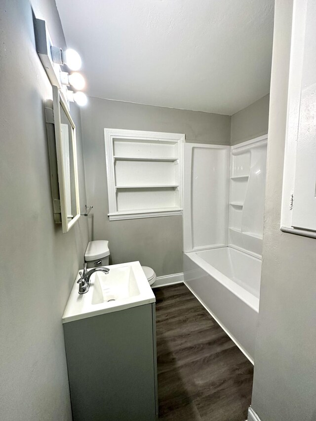 full bathroom with hardwood / wood-style flooring, vanity, toilet, and bathing tub / shower combination