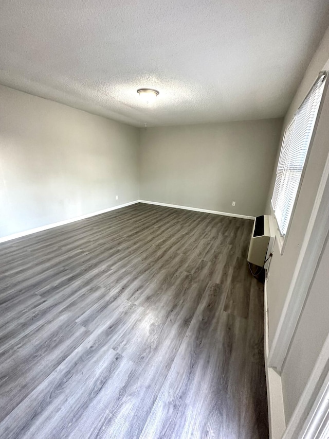 2 Bell Ave, Rossville, GA 30741 - spare room featuring dark wood-style floors, baseboards, and a textured ceiling