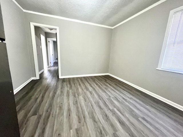 2 Bell Ave, Rossville, GA 30741 - spare room featuring dark wood-type flooring, a textured ceiling, baseboards, and crown molding