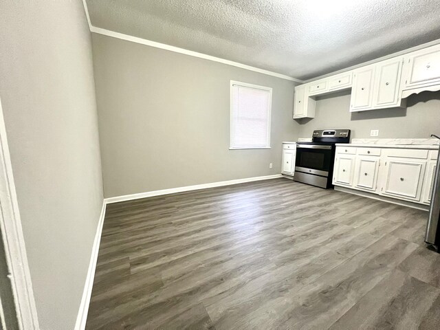 kitchen with white cabinets, ornamental molding, hardwood / wood-style flooring, and stainless steel range with electric cooktop