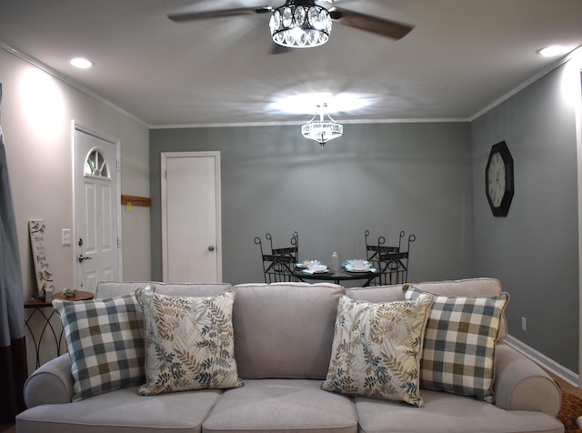 living room with ornamental molding and ceiling fan