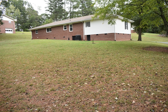 exterior space with central AC and a yard