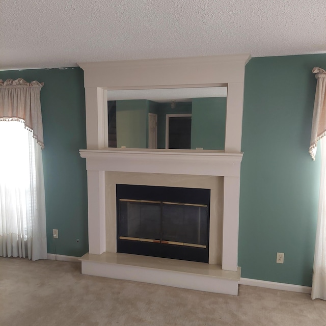 details with a textured ceiling, a fireplace, and carpet