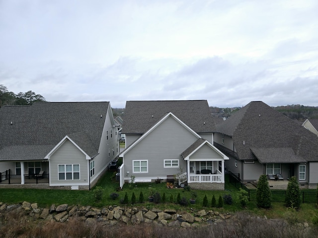 rear view of property with a porch