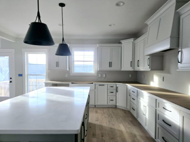 kitchen with white cabinetry, pendant lighting, and a center island