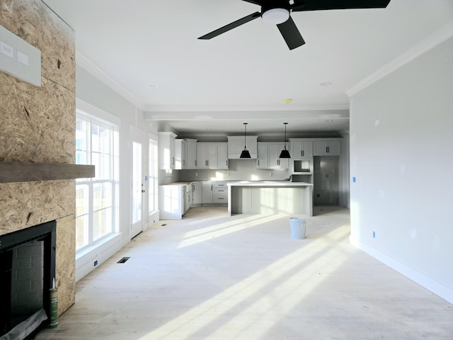 living room with ceiling fan and ornamental molding