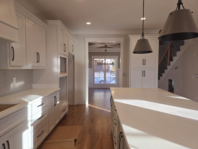 kitchen featuring white cabinetry, decorative light fixtures, and dark hardwood / wood-style flooring