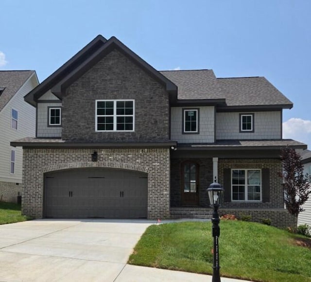 9885 Trestle Cir Unit 47, Ooltewah, TN 37363 - craftsman house featuring brick siding, a front yard, a garage, concrete driveway, and covered porch