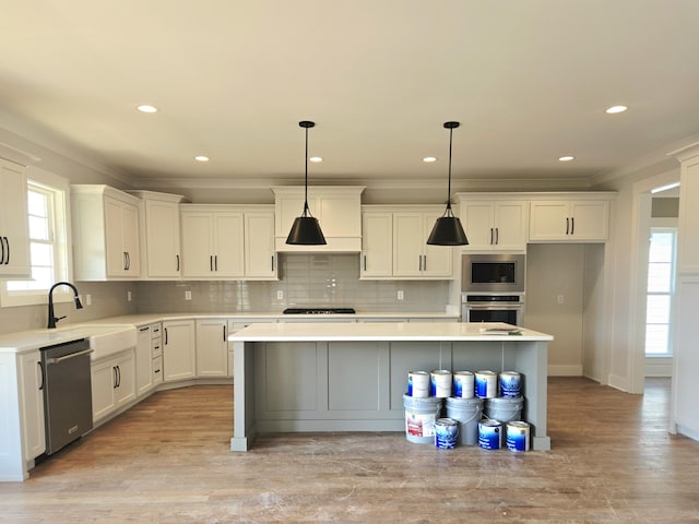9885 Trestle Cir Unit 47, Ooltewah, TN 37363 - kitchen with stainless steel appliances, plenty of natural light, ornamental molding, white cabinets, and recessed lighting
