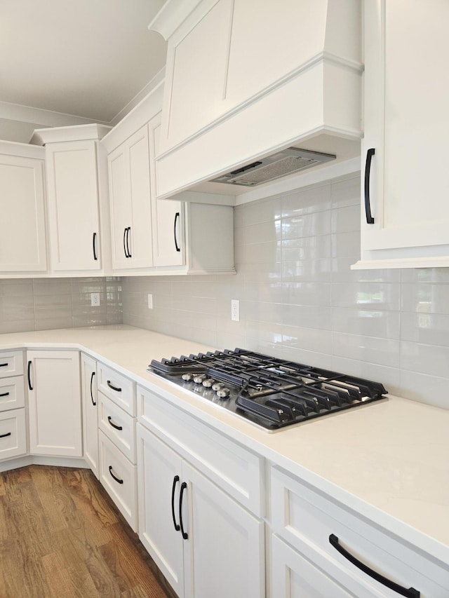 9885 Trestle Cir Unit 47, Ooltewah, TN 37363 - kitchen featuring premium range hood, stainless steel gas cooktop, white cabinets, light countertops, and wood finished floors