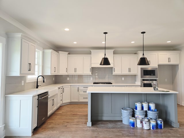 9885 Trestle Cir Unit 47, Ooltewah, TN 37363 - kitchen with stainless steel appliances, white cabinetry, light countertops, decorative backsplash, and pendant lighting