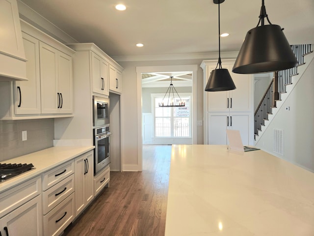 9885 Trestle Cir Unit 47, Ooltewah, TN 37363 - kitchen featuring stainless steel appliances, a chandelier, dark wood finished floors, decorative backsplash, and light countertops
