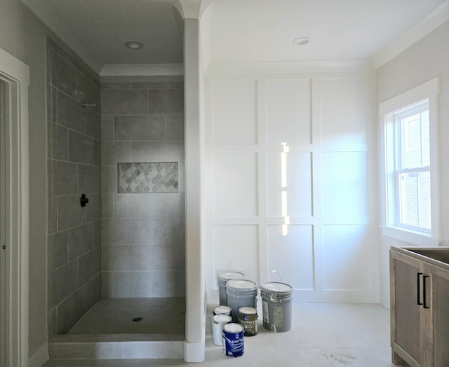 bathroom with a tile shower and vanity